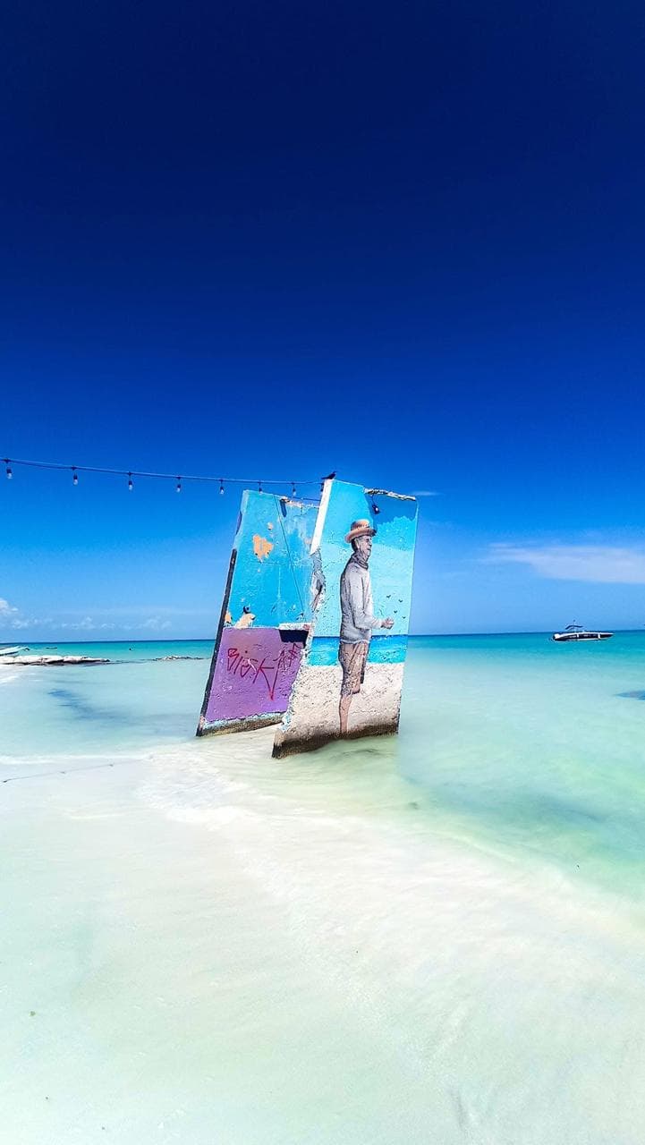 Painted wooden panel artwork on Holbox beach